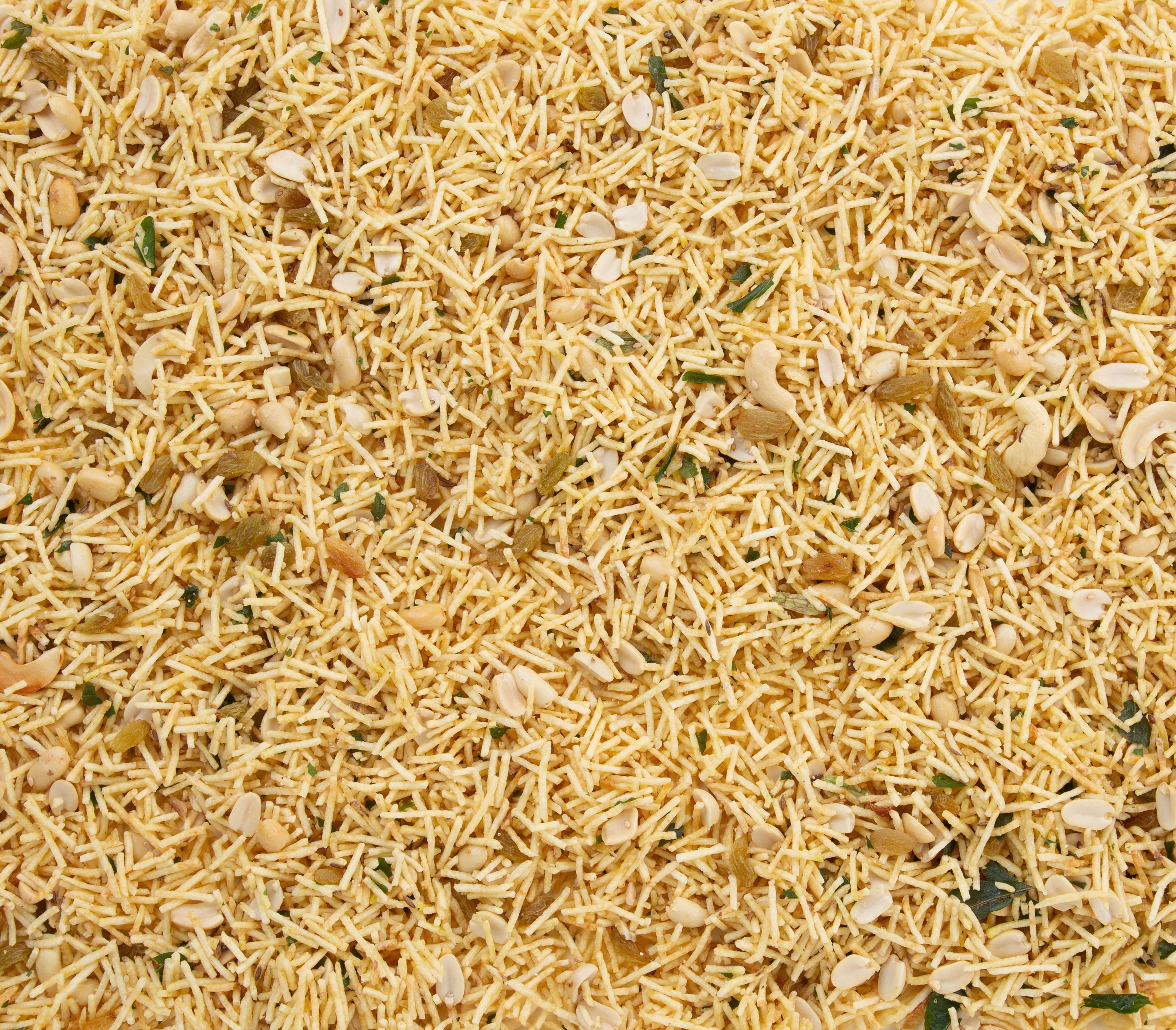 Close-up view of crunchy and lightly spiced farali chivda with peanuts and cashews.